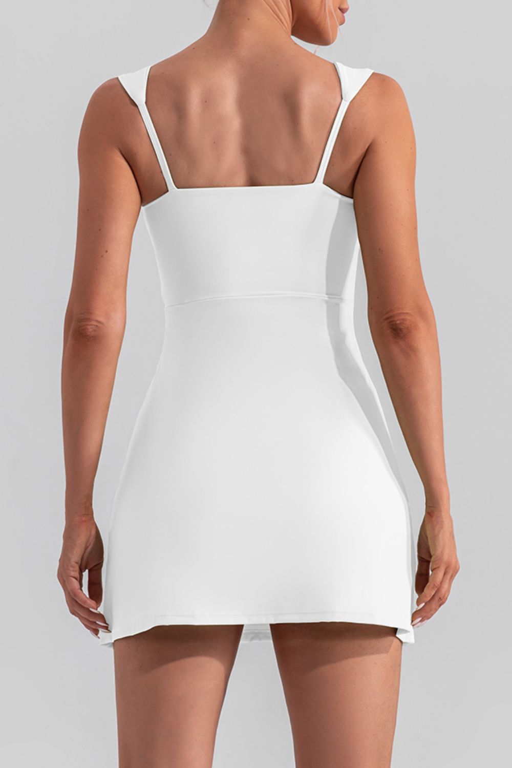 Chic square neck sleeveless mini dress with a stylish slit, perfect for active and casual wear.