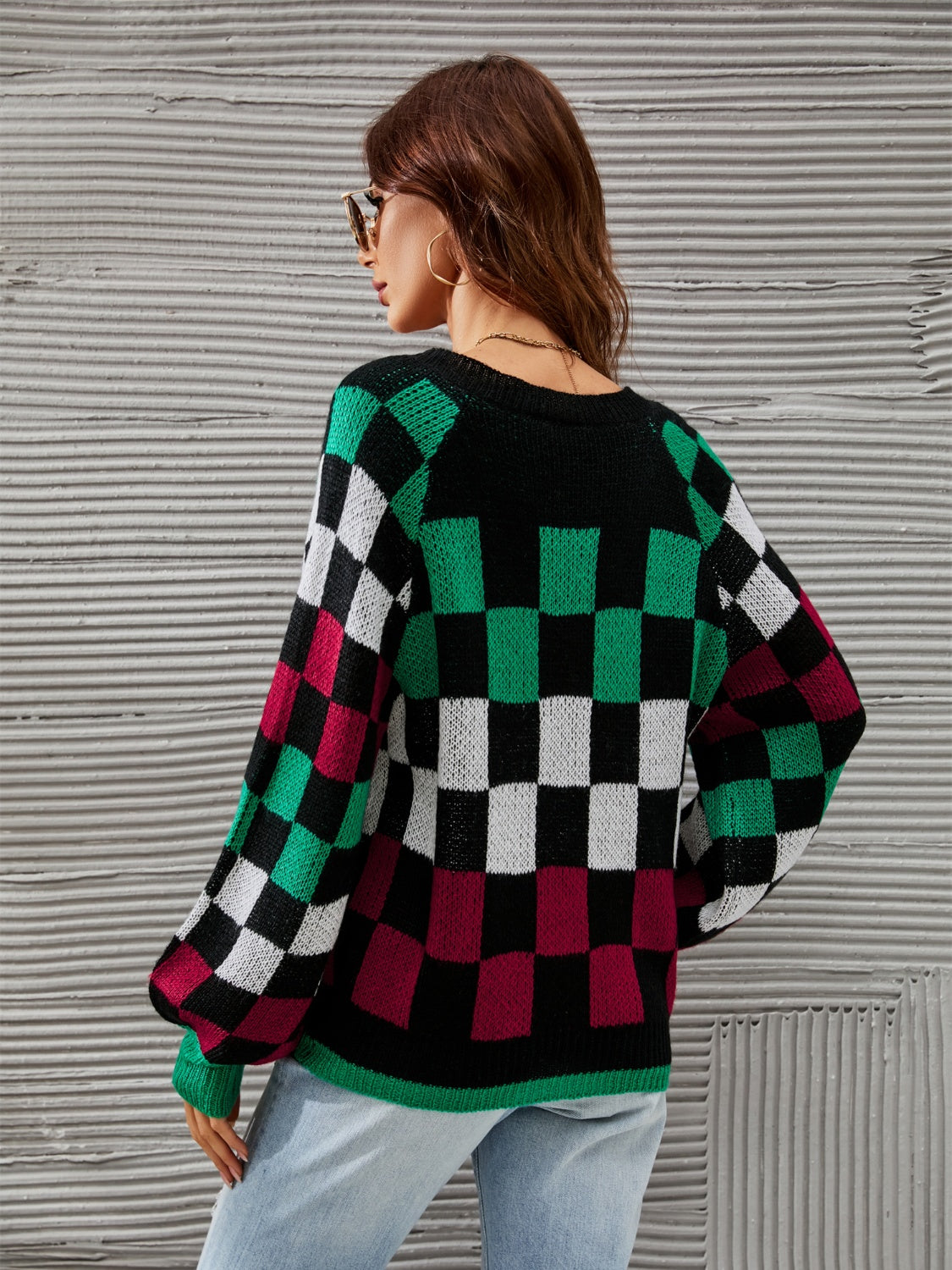 Trendy checkered v-neck sweater with lantern sleeves, perfect for a cozy and stylish look.