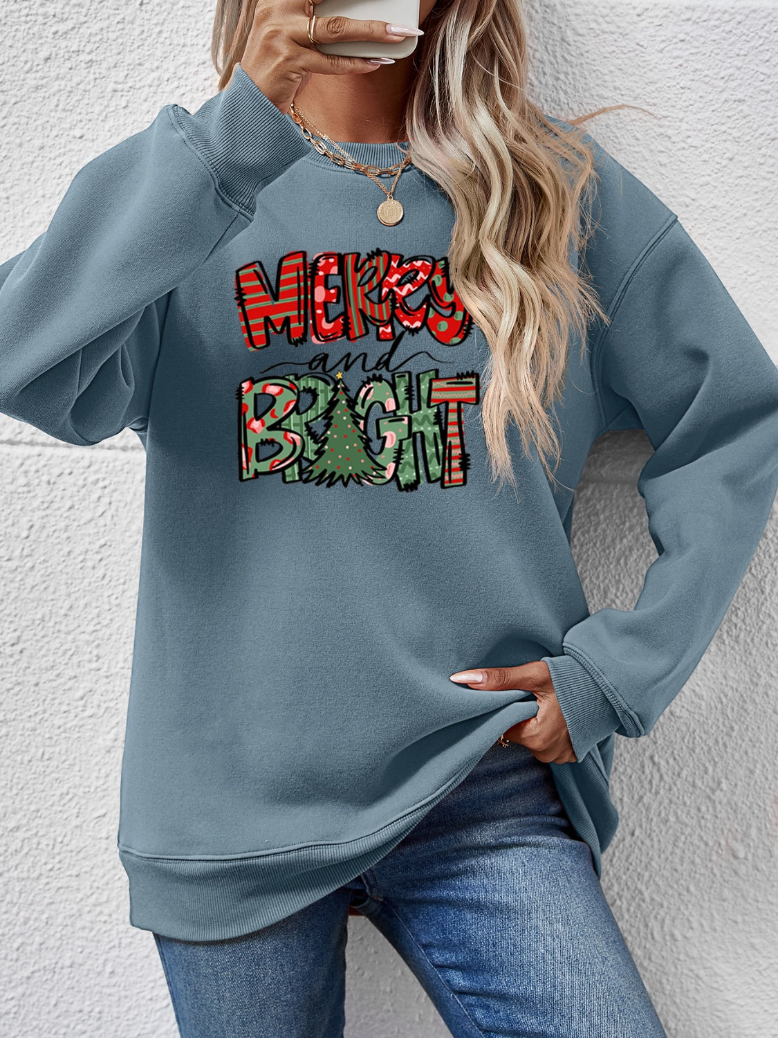 Festive ‘MERRY AND BRIGHT’ long sleeve sweatshirt, perfect for holiday cheer and cozy style.
