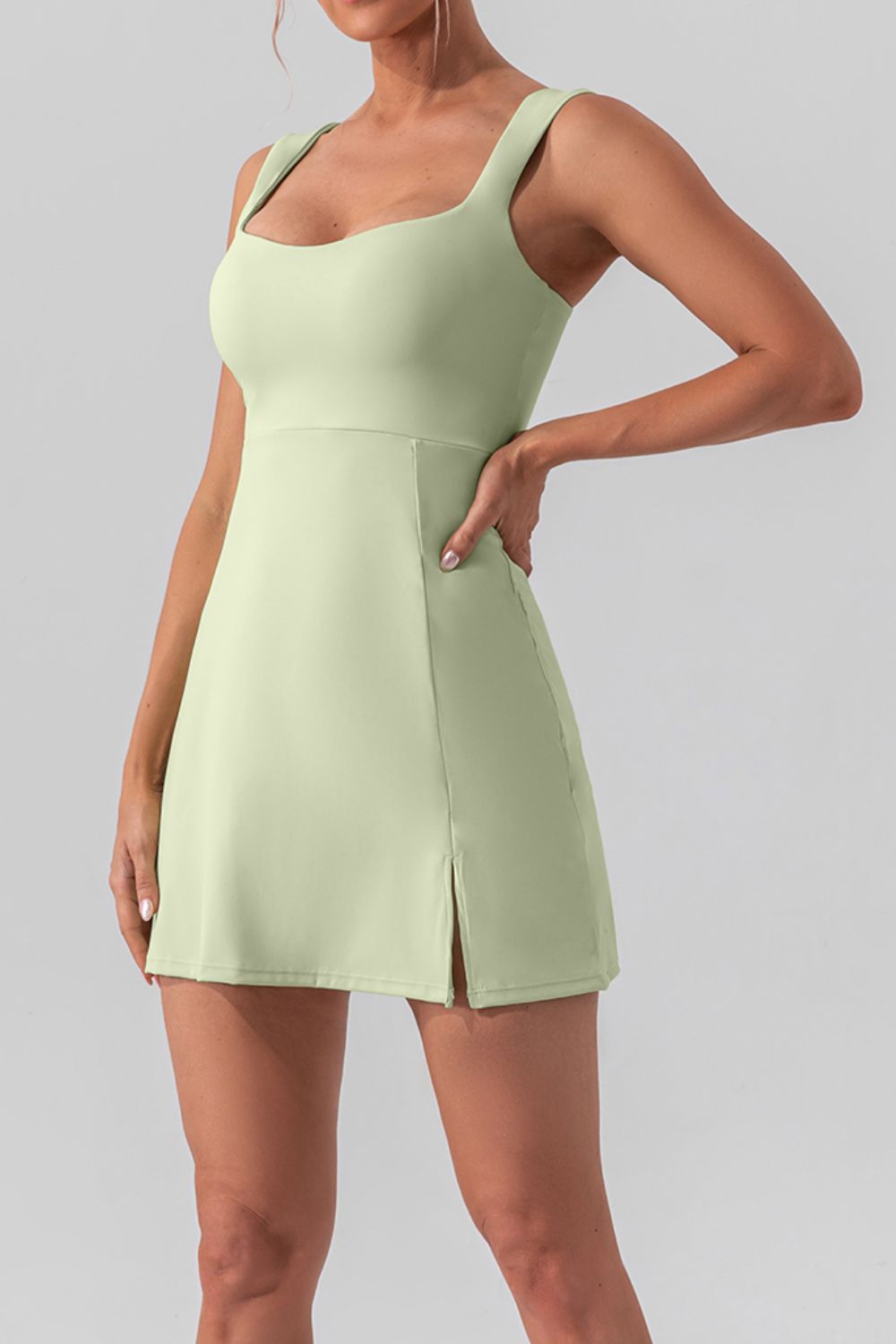 Chic square neck sleeveless mini dress with a stylish slit, perfect for active and casual wear.