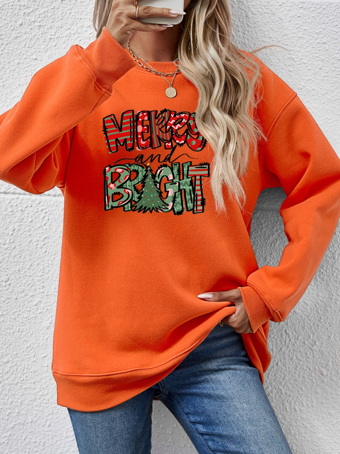 Festive ‘MERRY AND BRIGHT’ long sleeve sweatshirt, perfect for holiday cheer and cozy style.