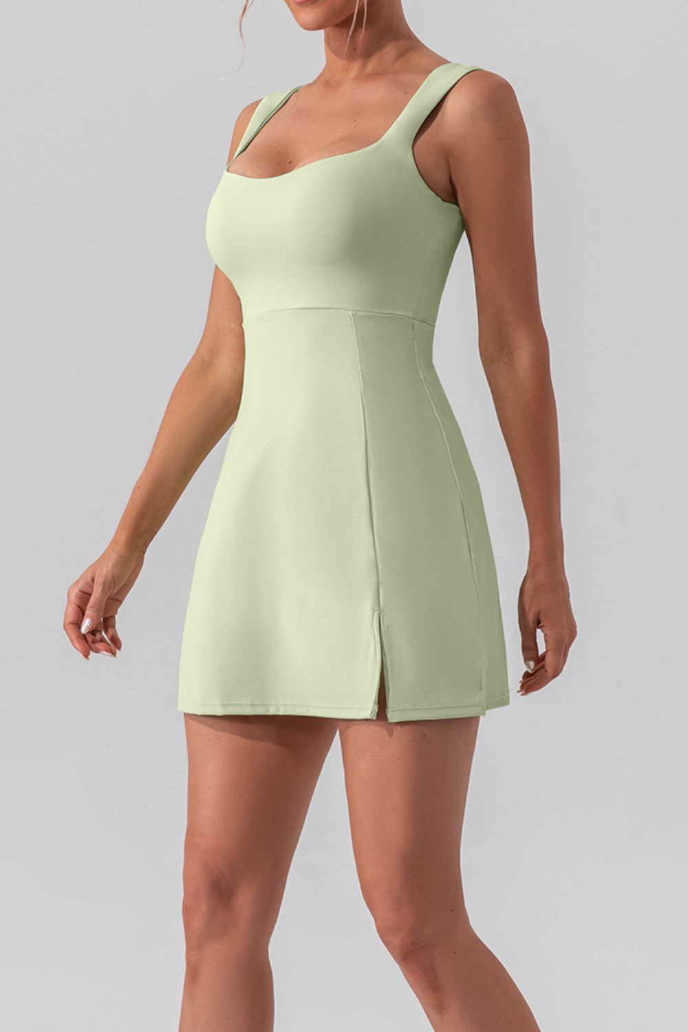 Chic square neck sleeveless mini dress with a stylish slit, perfect for active and casual wear.