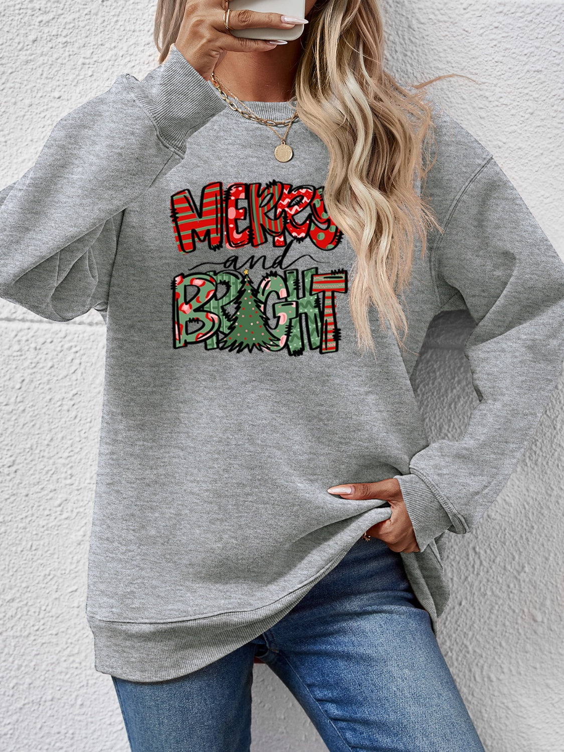 Festive ‘MERRY AND BRIGHT’ long sleeve sweatshirt, perfect for holiday cheer and cozy style.