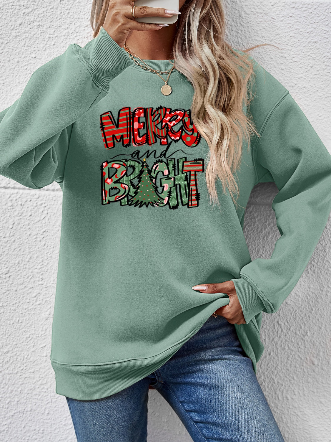 Festive ‘MERRY AND BRIGHT’ long sleeve sweatshirt, perfect for holiday cheer and cozy style.
