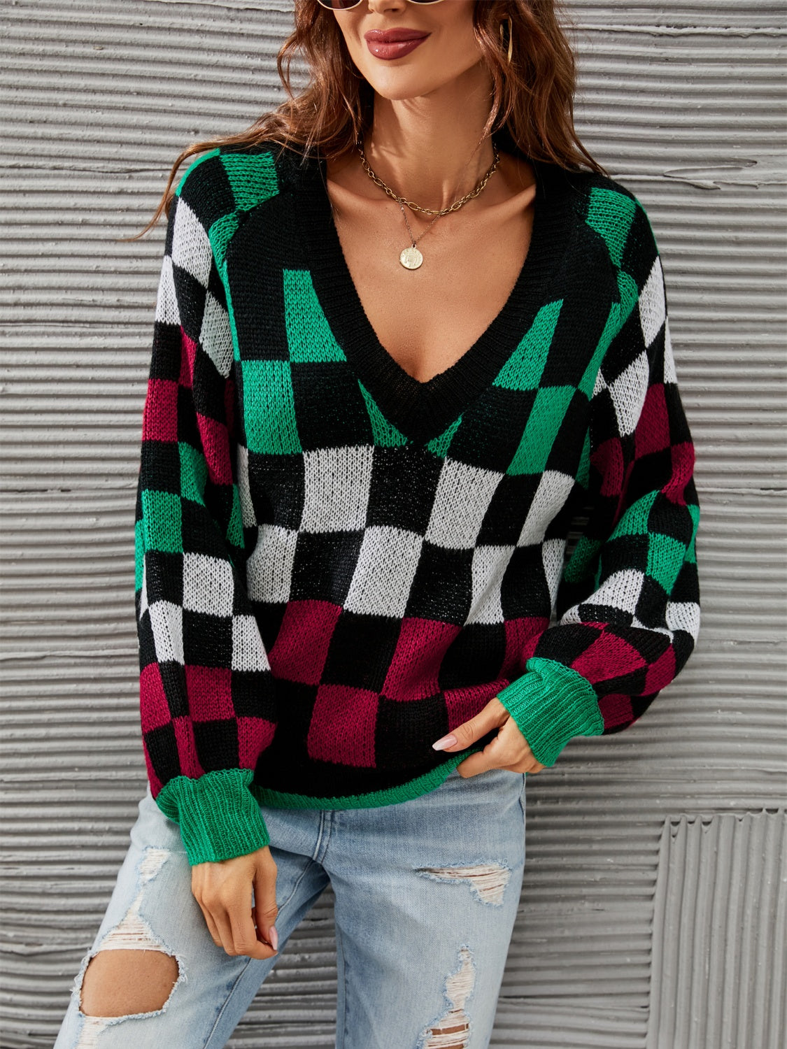 Trendy checkered v-neck sweater with lantern sleeves, perfect for a cozy and stylish look.