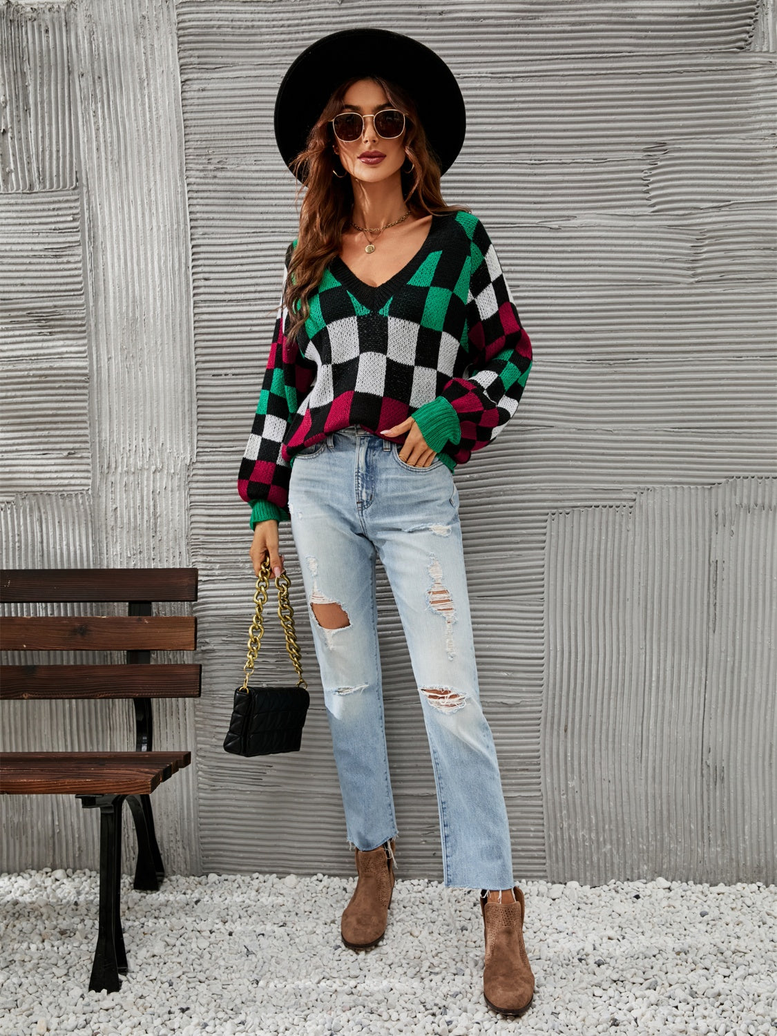 Trendy checkered v-neck sweater with lantern sleeves, perfect for a cozy and stylish look.