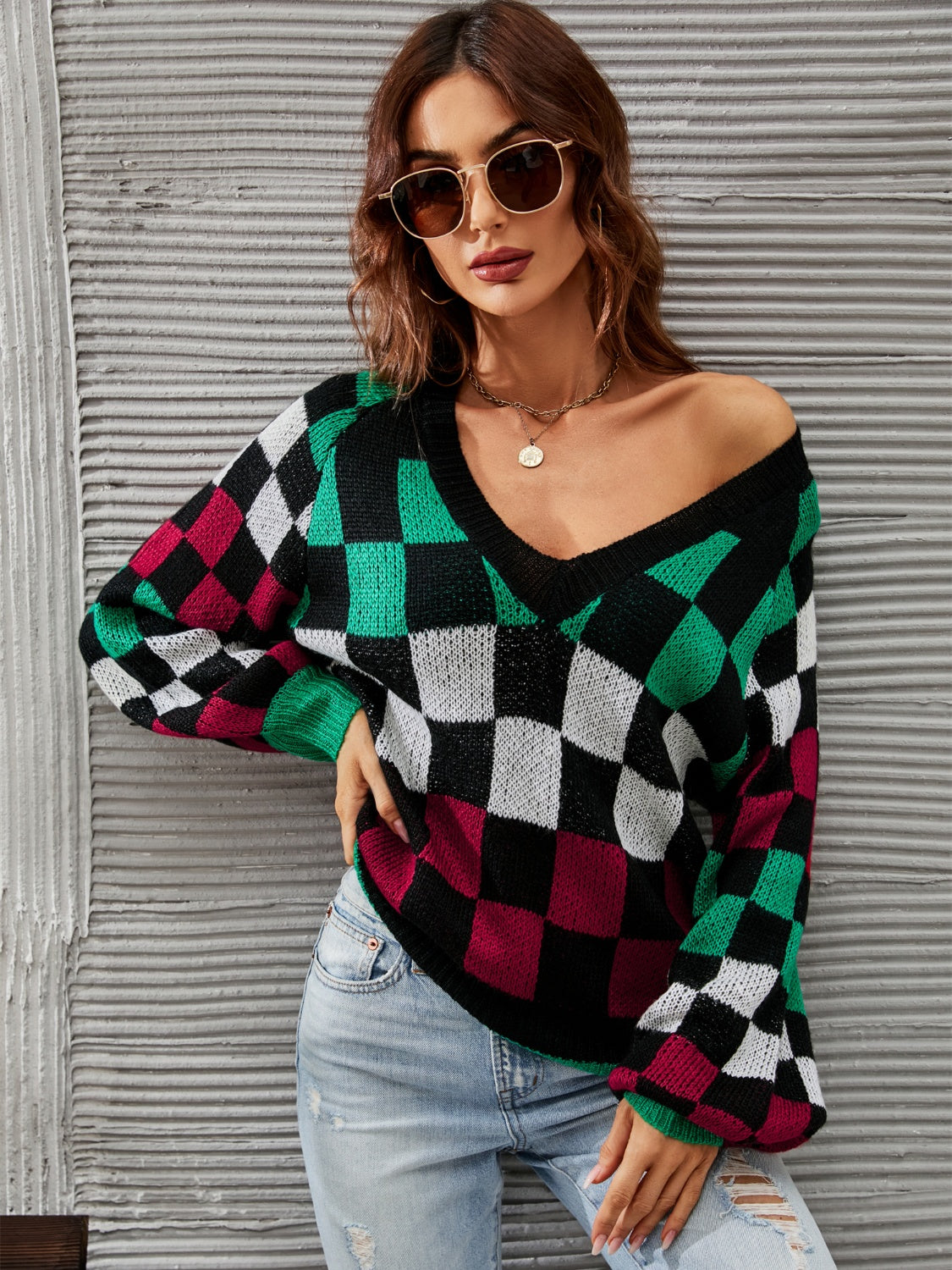 Trendy checkered v-neck sweater with lantern sleeves, perfect for a cozy and stylish look.