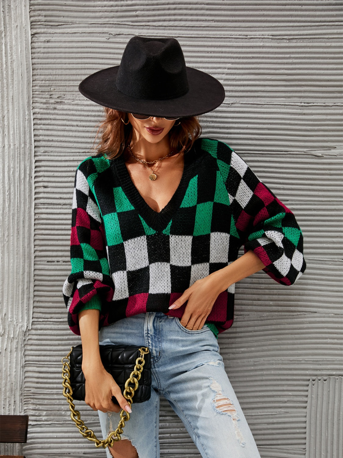 Trendy checkered v-neck sweater with lantern sleeves, perfect for a cozy and stylish look.