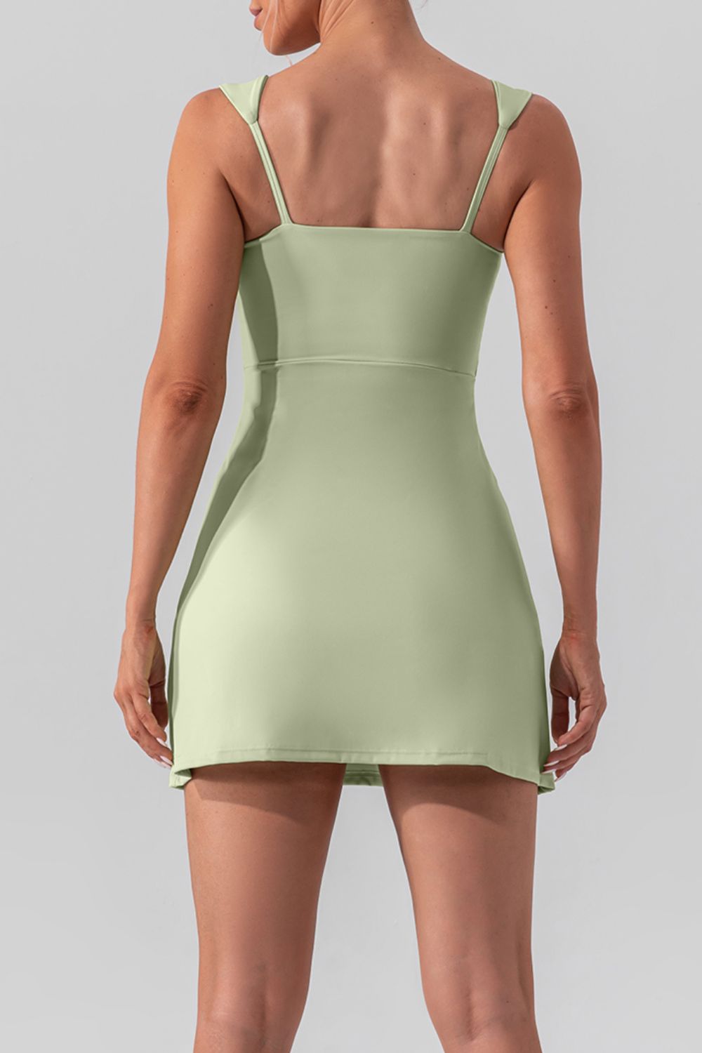 Chic square neck sleeveless mini dress with a stylish slit, perfect for active and casual wear.